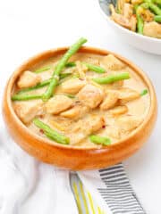 tofu with coconut milk and string beans in a wooden book