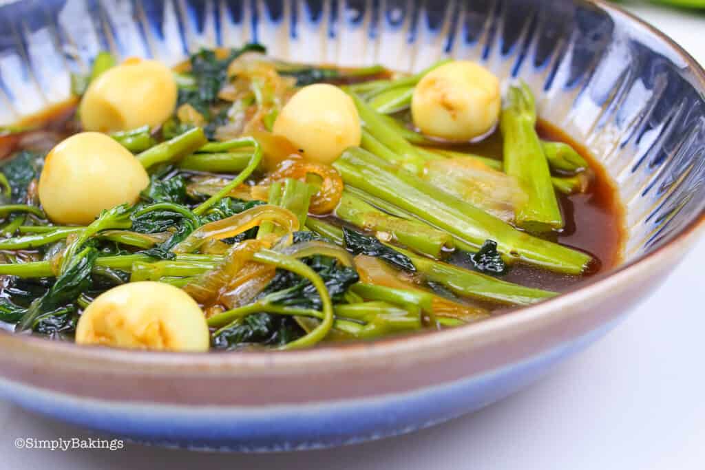 savory Vegetarian Kangkong with Quail Eggs in a glass bowl