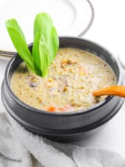 mung beans in coconut milk in black pot with wooden spoon
