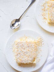 delicious maja blanca served on a white plate with a stainless spoon