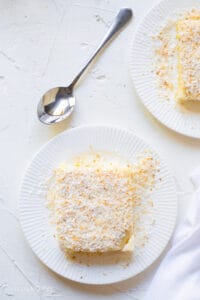 delicious maja blanca served on a white plate with a stainless spoon