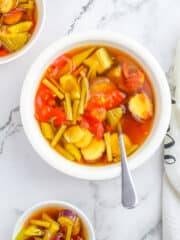 paksing demonyo served in a white bowl with a stainless spoon and