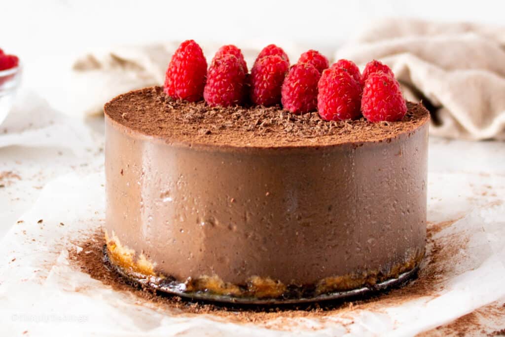 delicious No-Bake Vegan Chocolate Cake with fresh raspberries on top