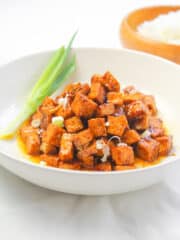 a bowl of tofu salpicao garnished with green onion
