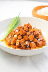 a bowl of tofu salpicao garnished with green onion
