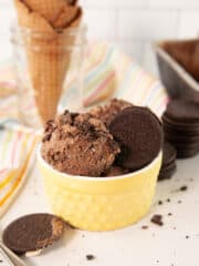 delicious chocolate ice cream in a yellow cup with waffle cones