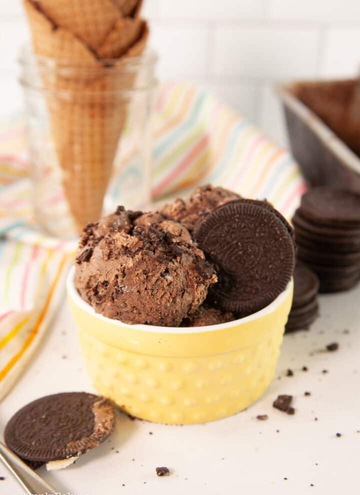 delicious chocolate ice cream in a yellow cup with waffle cones
