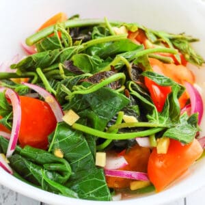 a healthy sweet potato leaves salad in a white bowl