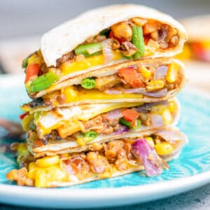 a stack of hearty Vegan Quesadillas on a serving plate