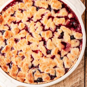 mixed berry cobbler in a white pie plate