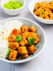 healthy and delicious crispy orange tofu served in a bowl with steamed rice