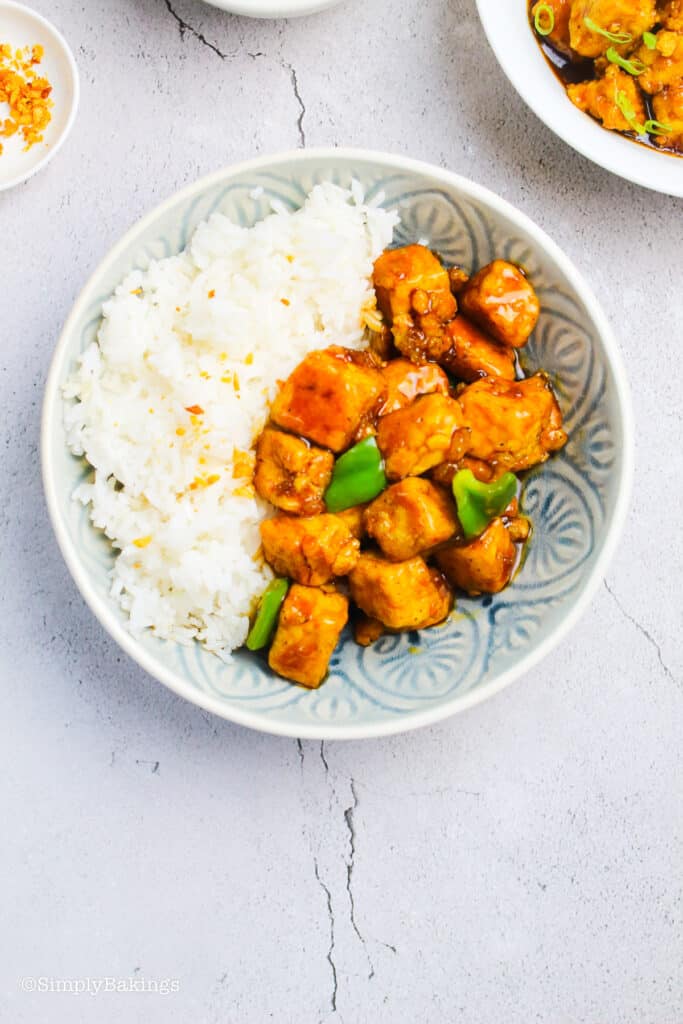 serve the crispy orange tofu in a bowl with steamed rice