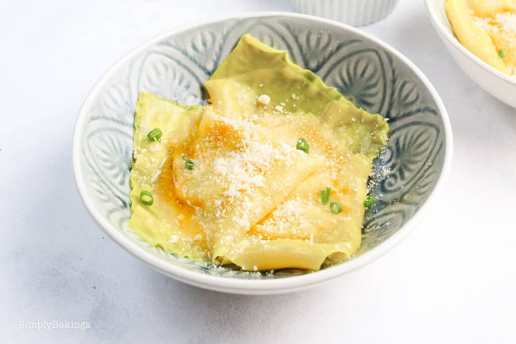 delicious kalabasa ravioli with parmesan cheese topping served in a bowl
