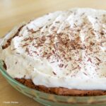 Creamy French Silk Cheesecake topped with whipped cream