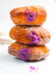 ube malasadas on a white surface