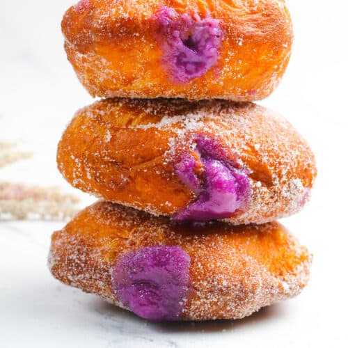 ube malasadas on a white surface