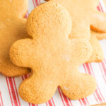 soft and delicious gluten free gingerbread men cookies on a red and white plate