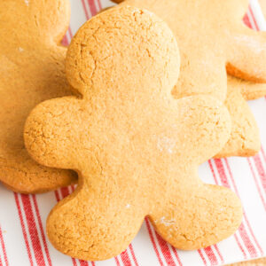 soft and delicious gluten free gingerbread men cookies on a red and white plate