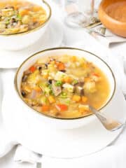 a delicious and healthy sour cabbage soup served in a white bowl