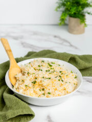 filipino garlic rice served on white bowl with wooden spoon