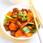 a bowl of Vegan Kung Pao Tofu with chopsticks