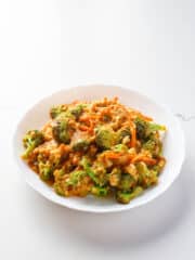 a bowl of broccoli and tofu in spicy almond sauce