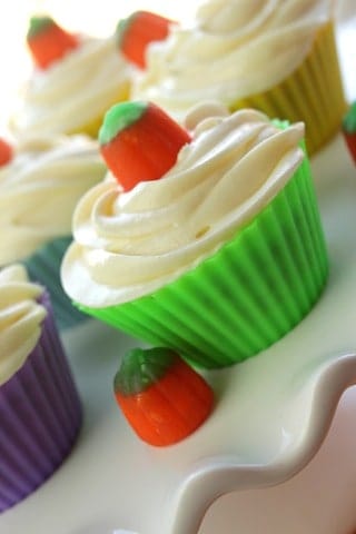 pumpkin cupcakes on a white cake stand