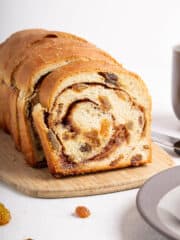 rich, moist vegan bread bursting with juicy raisins under a blanket of warm cinnamon flavor