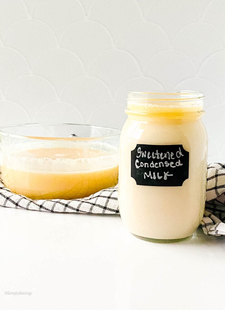 delicious homemade sweetened condensed milk in a glass bowl and jar