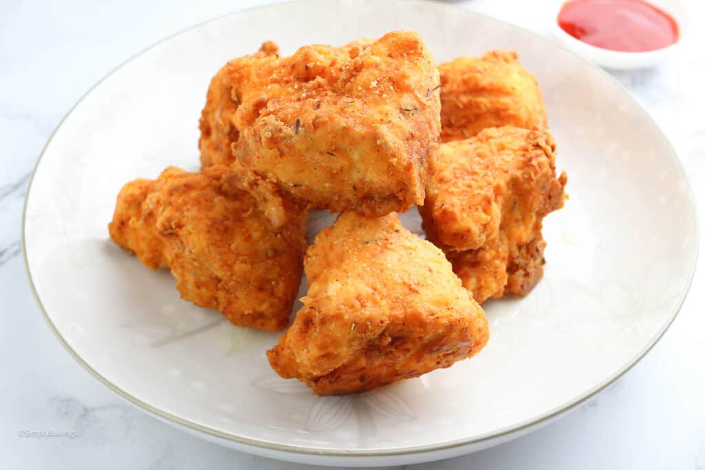 crispy vegan fried chicken with hot sauce on the side