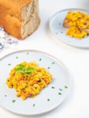 Tofu Scramble on white plate garnished with chopped chives
