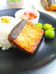Marinated Bangus on a black round plate