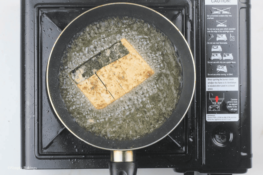 fried tofu slices with nori sheet in a pan