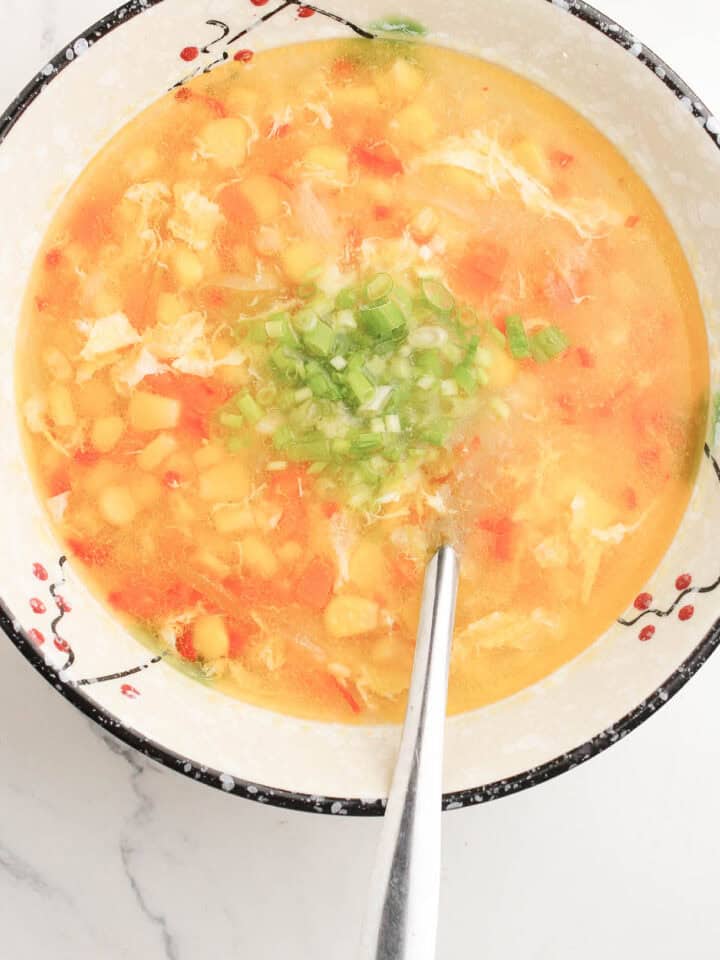Spoon in a bowl of Filipino Corn Soup