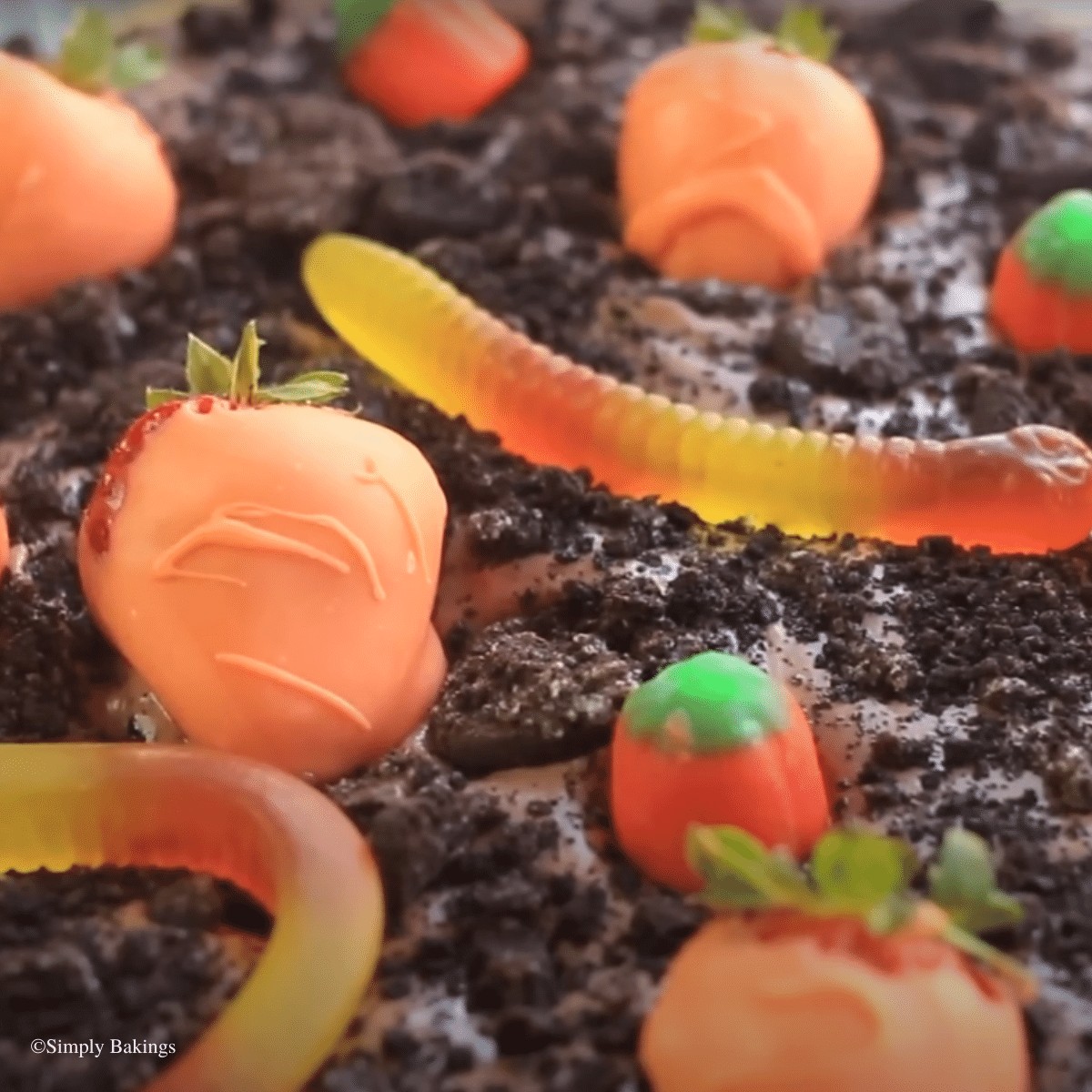 yummy dirt pudding with gummy worms and strawberries