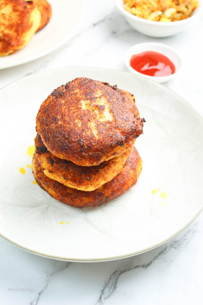 a stack of stuffed Filipino potato cakes on a white plate