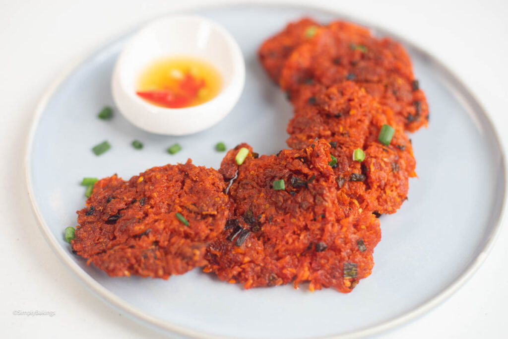okoy on a white plate with vinegar-dipping sauce
