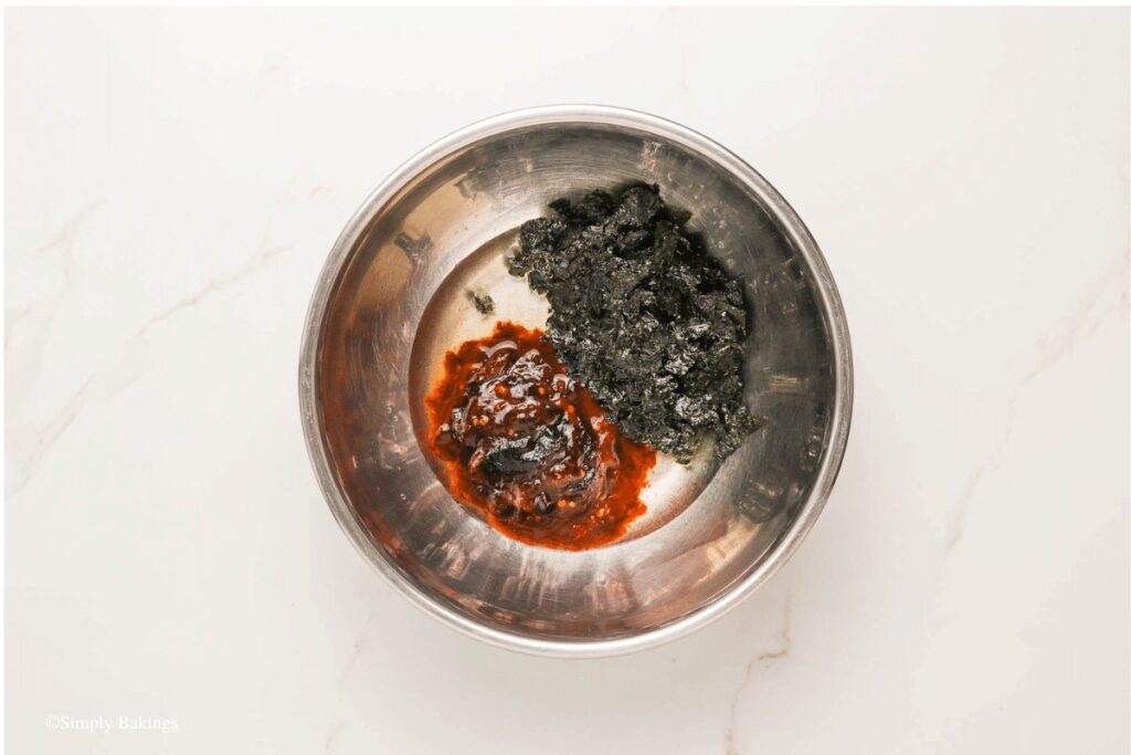 water, gochujang and chopped nori on a bowl