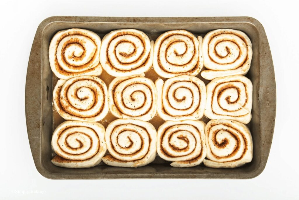 chai spice cinnamon dough rolls placed in baking pan