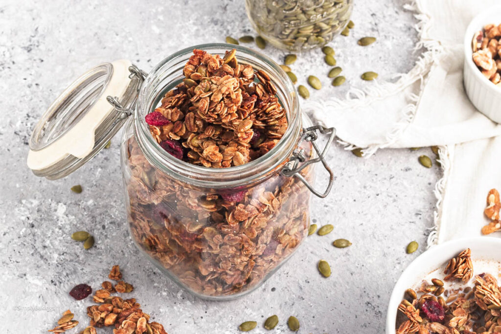 crunchy pumpkin spice granola in an open lid jar