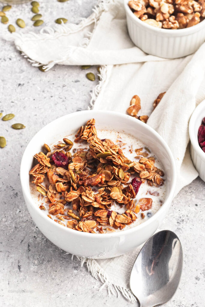 vegan pumpkin spice granola with milk on a small bowl