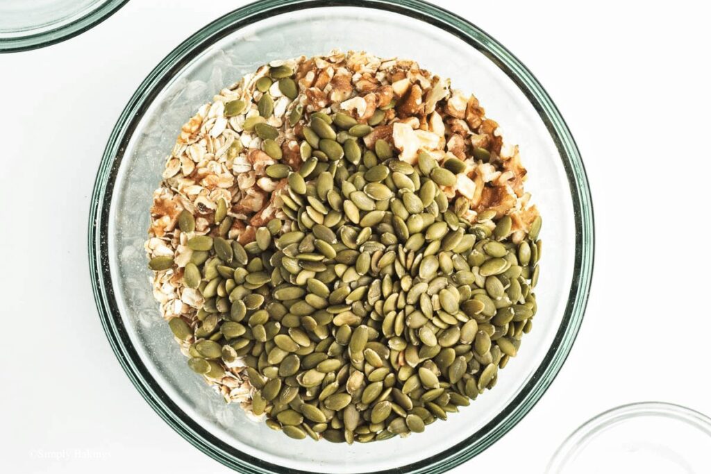 rolled oats, chopped walnuts, and pepitas on a bowl