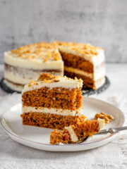Carrot cake on a white plate with fork