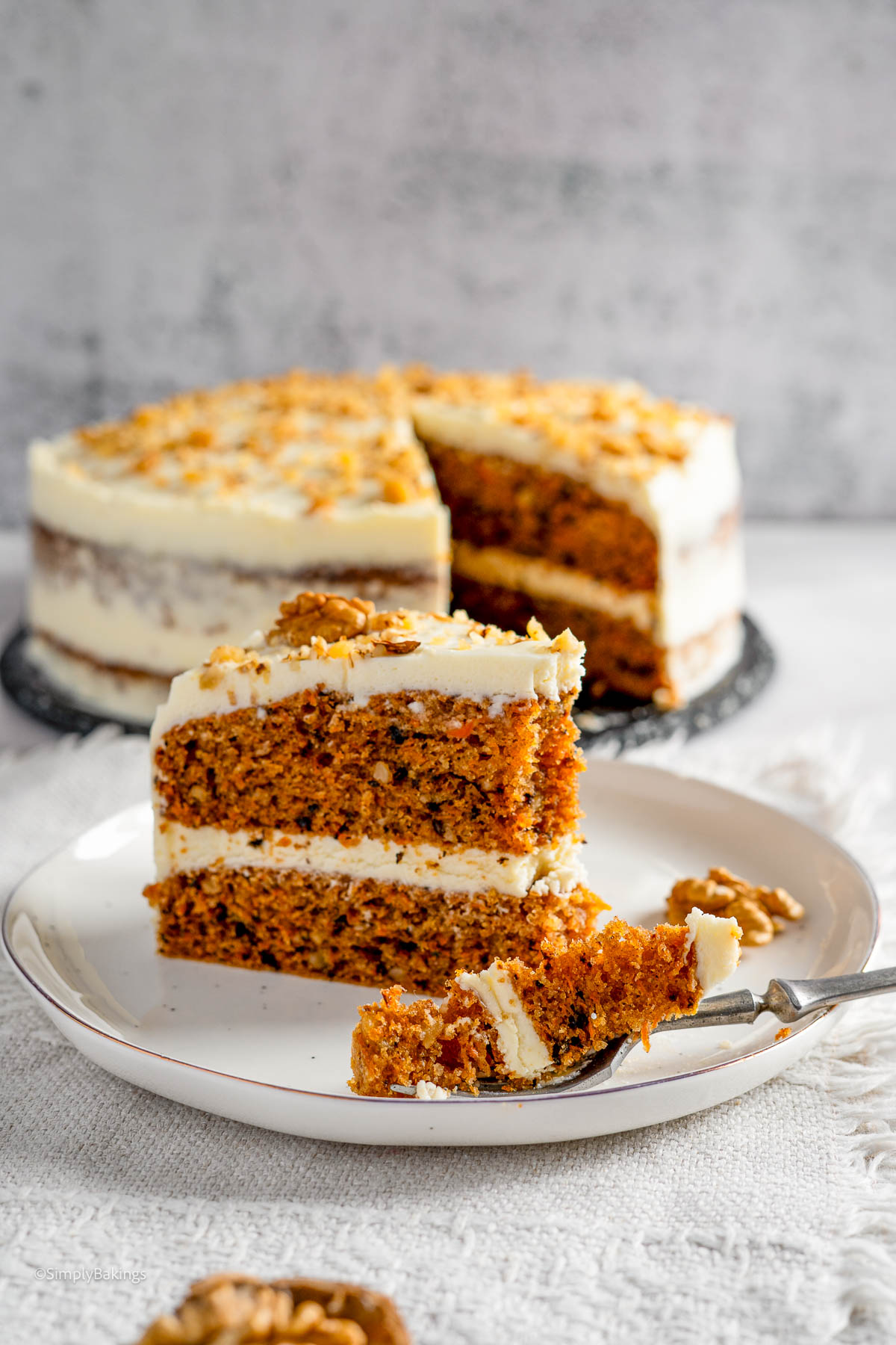 Carrot cake on a white plate with fork