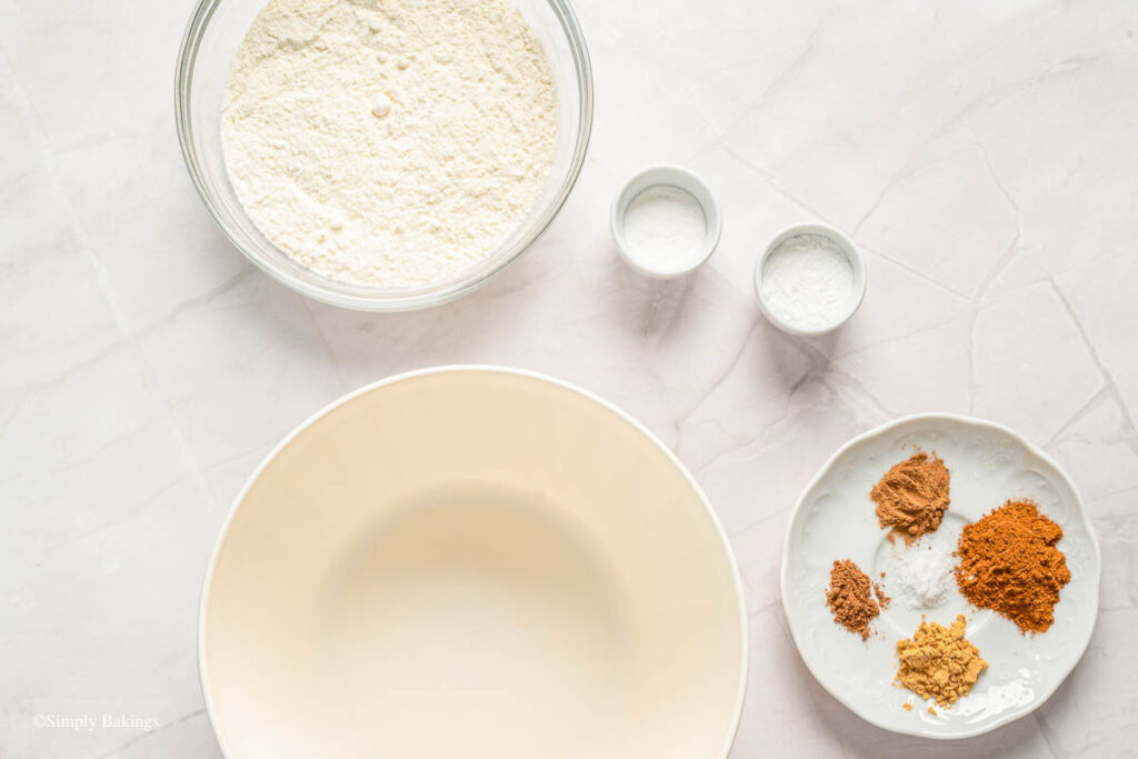 Bowls of ingredients surrounding a big bowl
