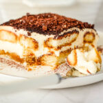 a slice of Filipino-style tiramisu sprinkled with chocolate grates and paired with spoon