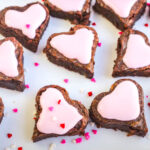 brownie hearts on a white plate sprinkled with mini hearts