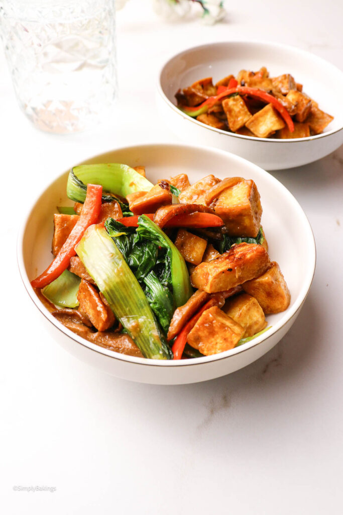Crispy tofu with sautéed vegetables on a plate