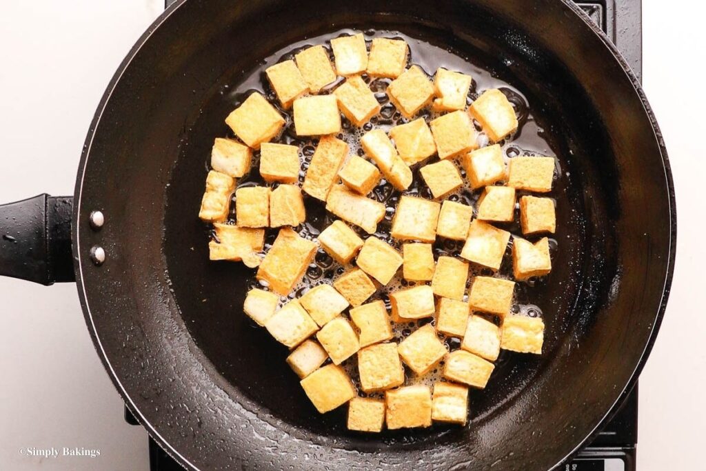 Dices of tofu cooked in an oiled pan