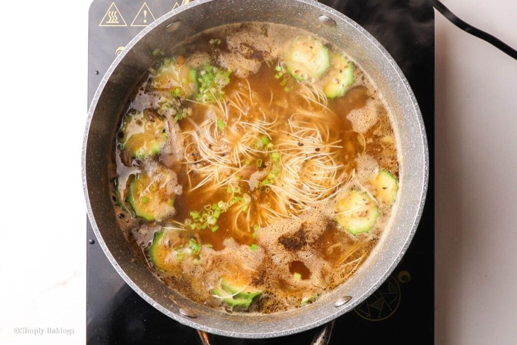 Vegan almondigas boiling in a pan
